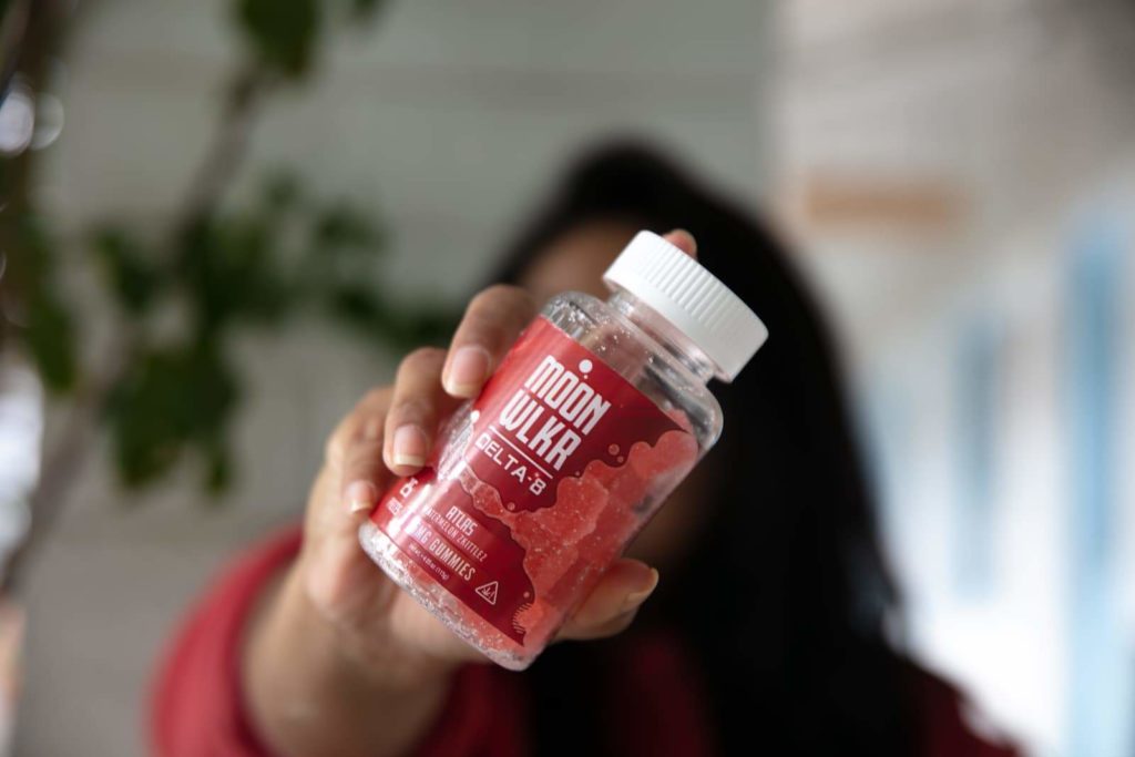 Girl holding delta 8 gummies