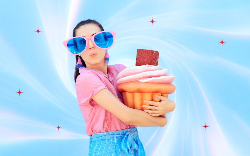 A woman holding a cupcake and Delta 8 gummy