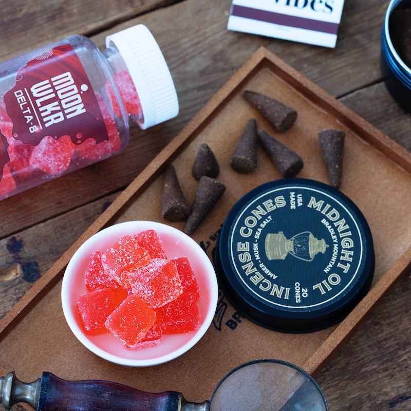 Delta 8 gummies on a tray with incense