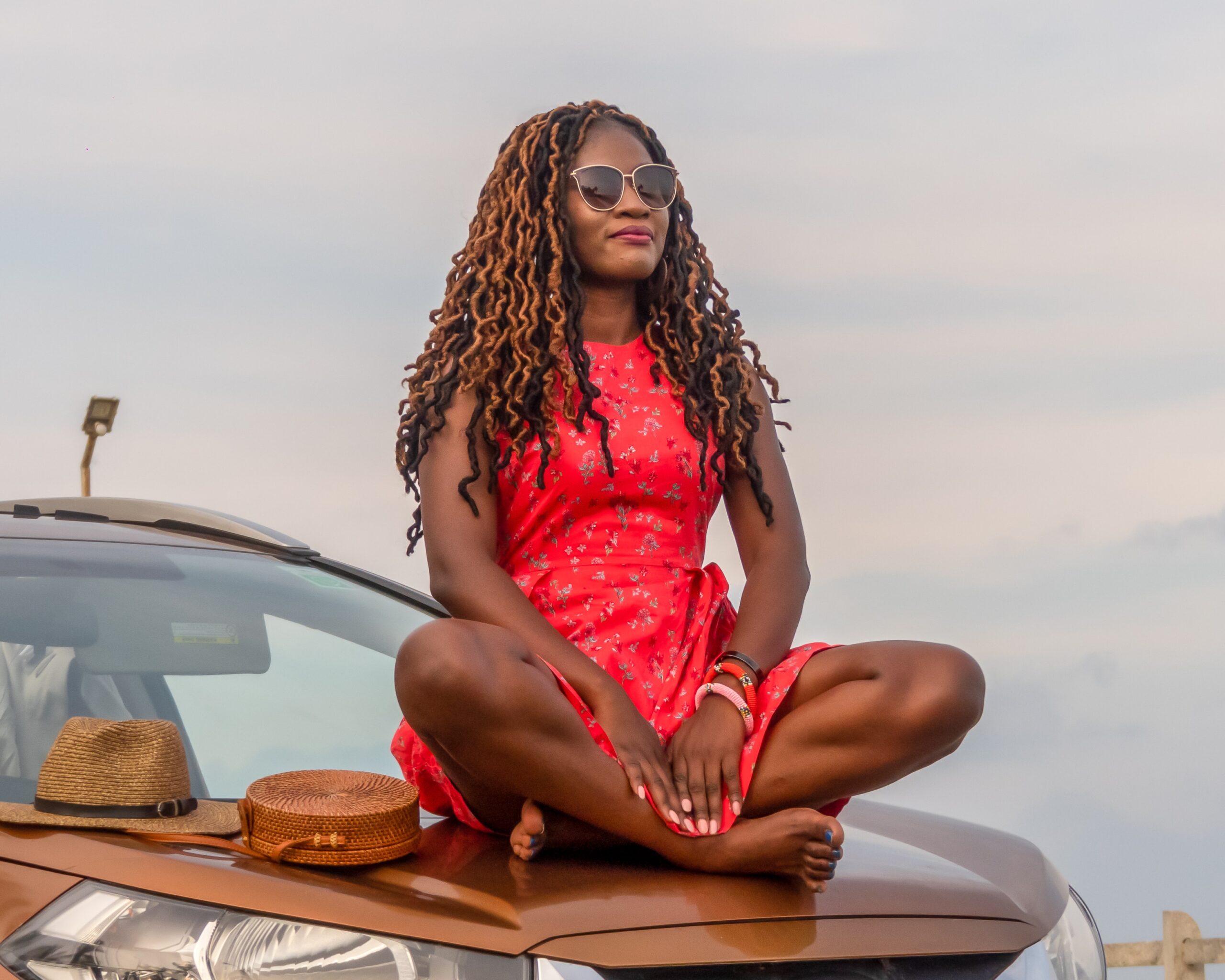 woman_sitting_on_car_hood