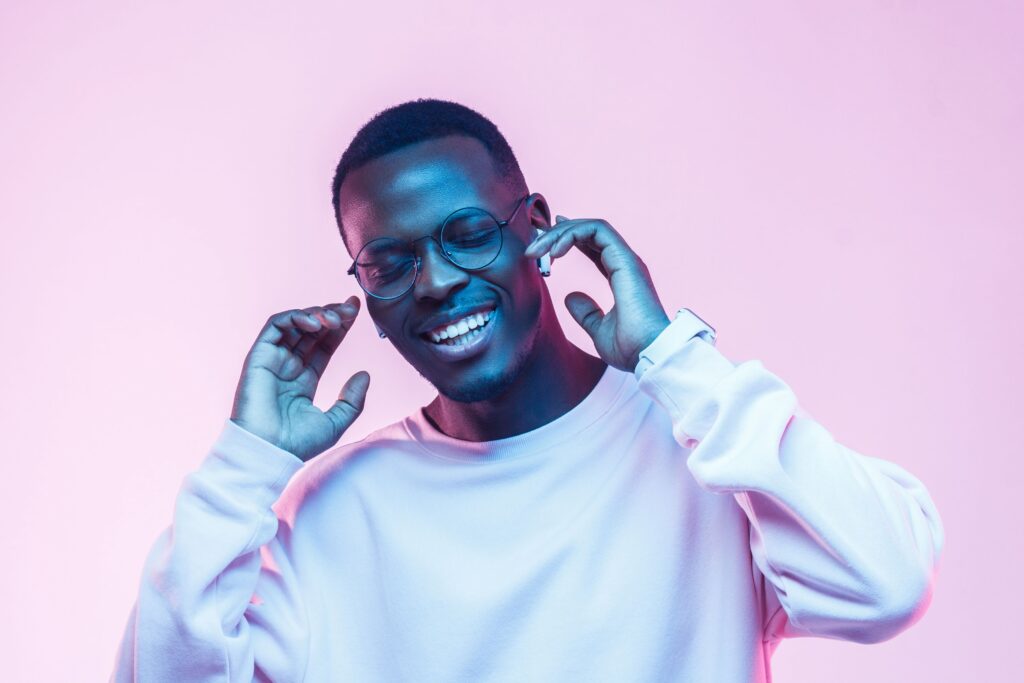 A man smiling with ear buds in listening to music