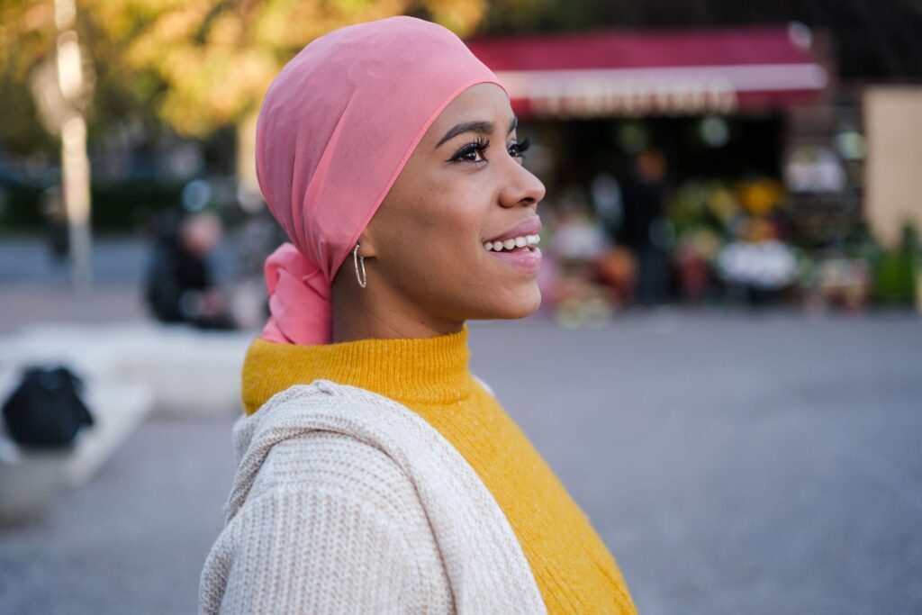 A woman smiling and looking up and outward